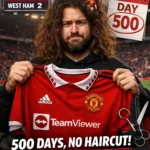 Manchester United fan ‘The United Strand’ holds a red Man Utd shirt in a stadium as graphics show a 2–2 West Ham draw and ‘Day 500’ of his no-haircut challenge.
