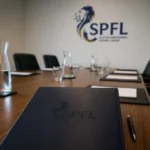 SPFL board 2026/27 meeting room with branded folder and logo on the wall