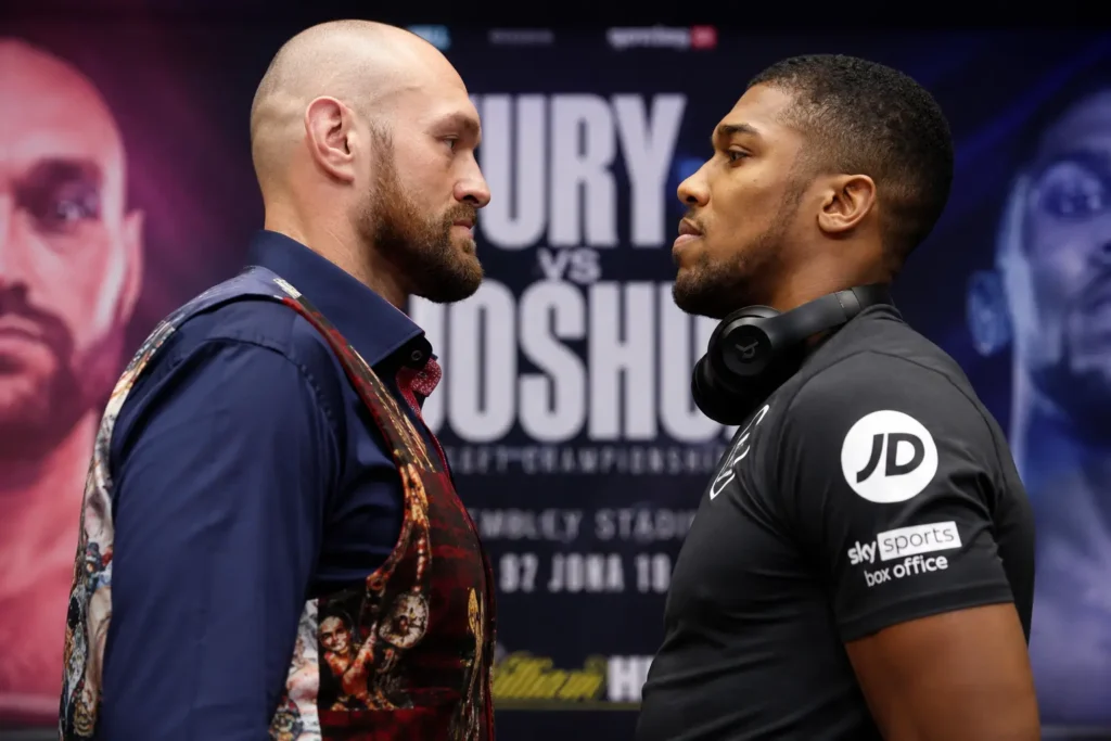 Fury vs Joshua Wembley face-off with Tyson Fury and Anthony Joshua staring each other down in front of the fight poster