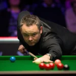 Stephen Maguire Championship League match with a professional snooker player lining up a shot during the tournament in Leicester.
